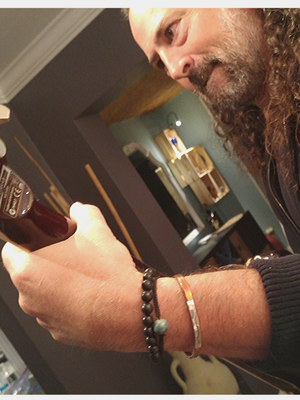 guy playing guitar wearing bracelets